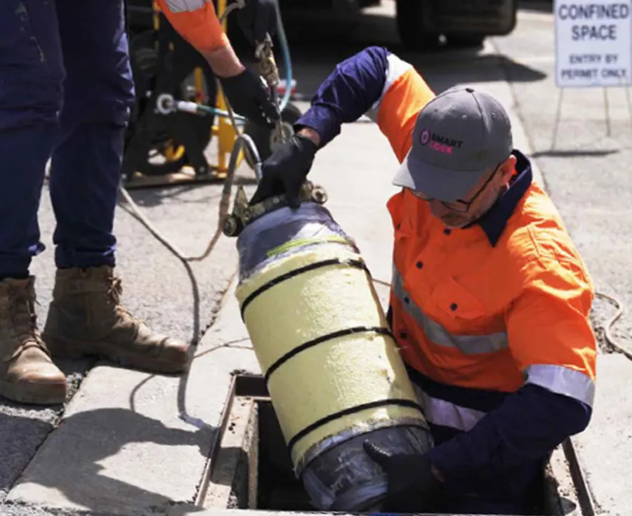 Two men repairing a pipe.jpg